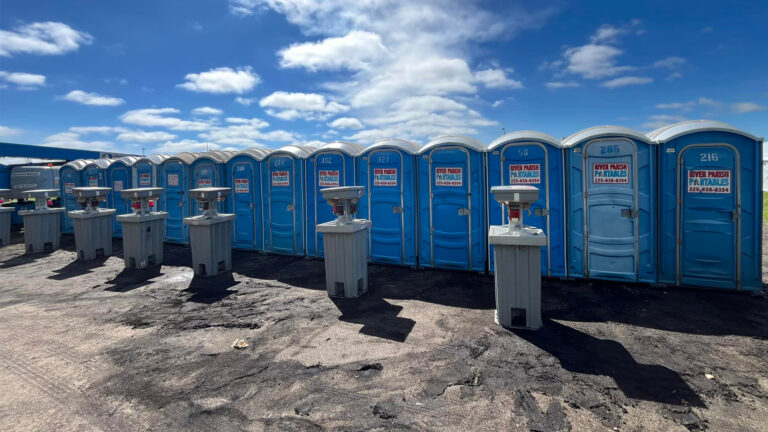 Row of portable restrooms and hand wash stations at a Louisiana industrial job site