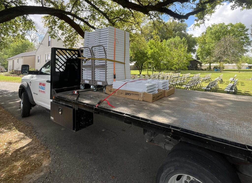 Table and chair rentals with portable restroom setup for outdoor event in West Baton Rouge Louisiana